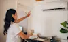 Woman operating her new split system in her home office