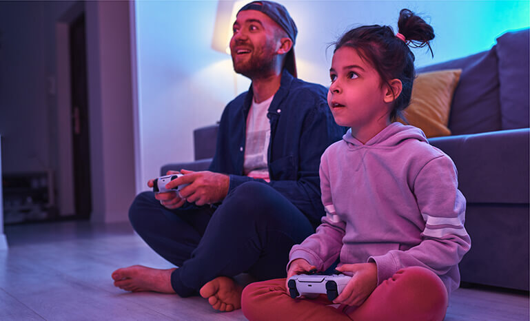 A father plays games with his young daughter