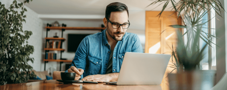 a man sitting outside on his laptop doing work 