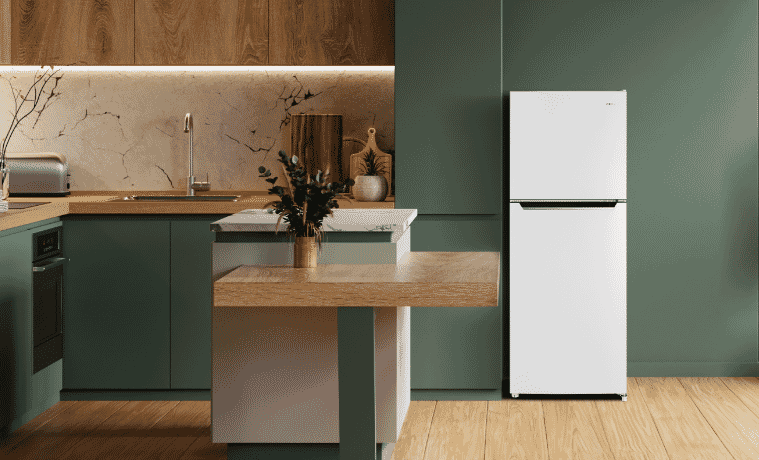 A white CHiQ fridge sits in a grey kitchen with white walls