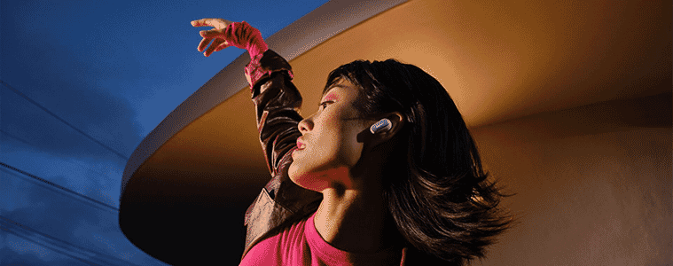 A woman dancing while wearing the Bose Quietcomfort Ultra Earbuds