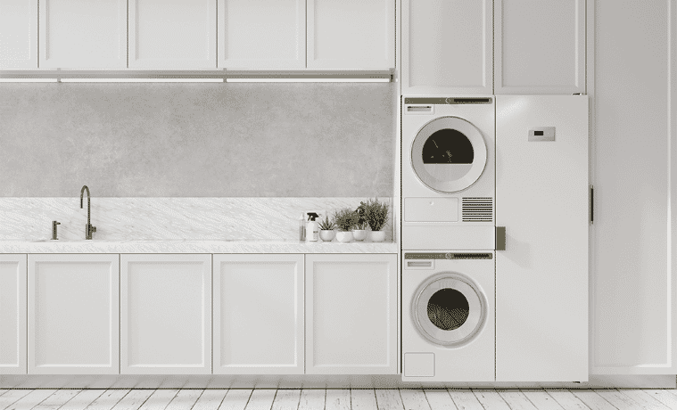 A stacked washer and dryer in a large white laundry