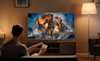 a boy playing PlayStation on his TCL TV