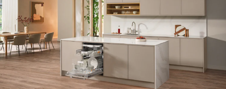 Integrated dishwasher open in a kitchen island, blending into neutral cabinetry in an open-plan kitchen