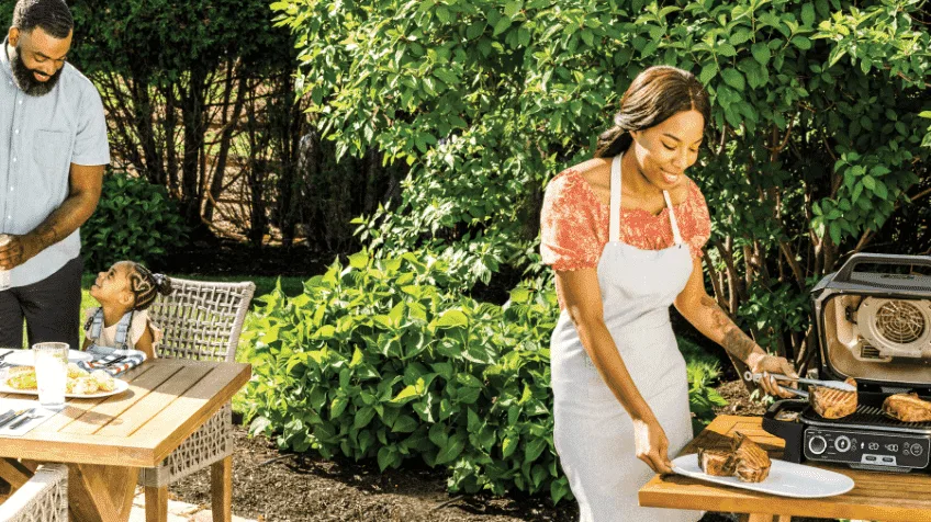 Family cooking outside with Ninja