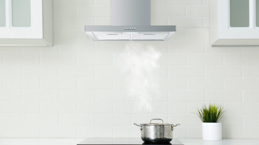 A woman turns on her integrated Haier rangehood