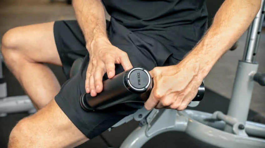Man using Homedics Massage gun at the gym The Good Guys