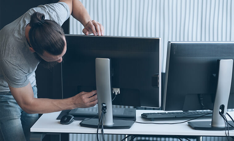 A man fixes his home office desktop computer