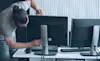 A man fixes his home office desktop computer