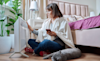A woman and a cat keeping warm in front of their new portable heater
