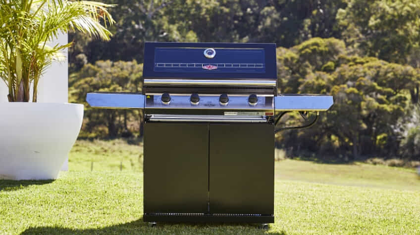 Black BeefEater freestanding BBQ in stunning green backyard