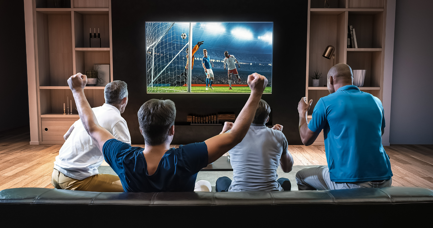 A group of friends watch a soccer game on TV