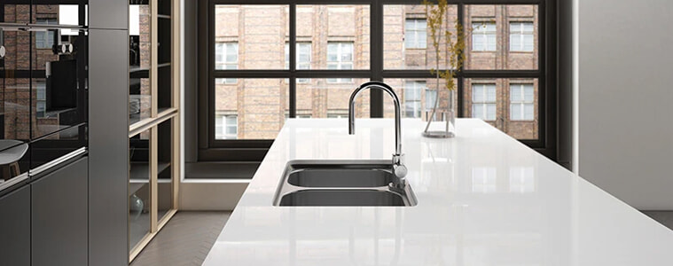 A chrome sink in the kitchen of a sleek modern apartment
