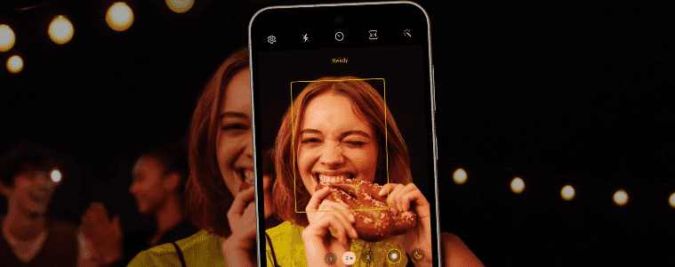 a woman taking a photo of another woman eating 