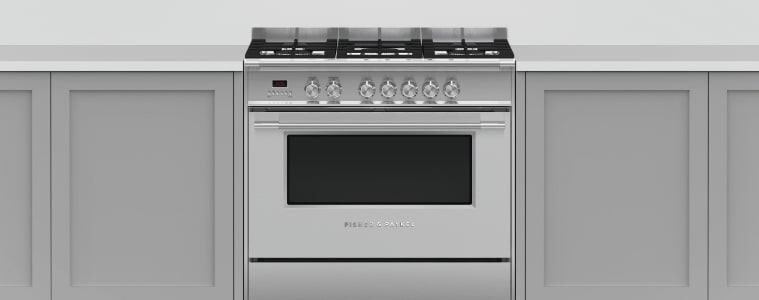 A chrome freestanding oven in a white kitchen