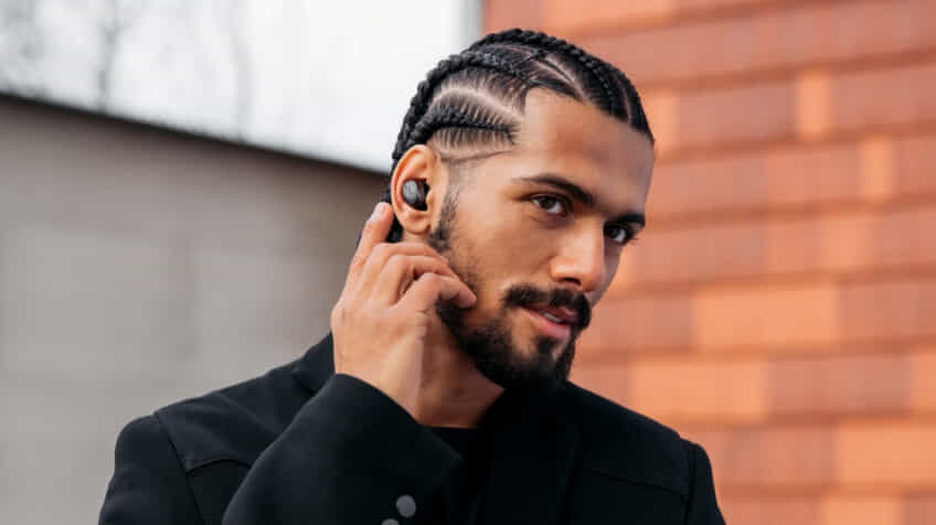 Man using call function on his Sennheiser MOMENTUM 4 headphones   The Good Guys