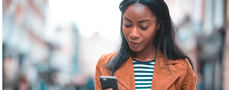 Closeup of a woman holding a smartphone in her hands checking a text or email
