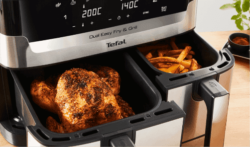 A close up of the Tefal Dual Easy Fry cooking chicken and chips