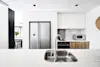 A stylish side by side fridge freezer in a modern white kitchen
