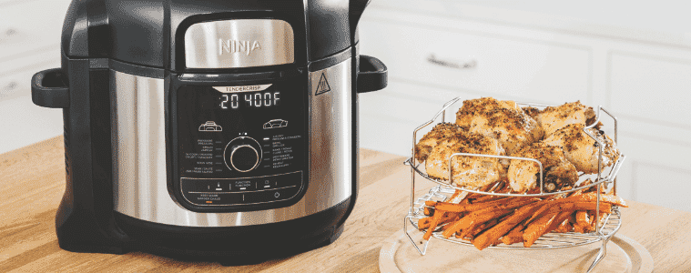 Ninja air fryer on a bench with some delicious fried snacks