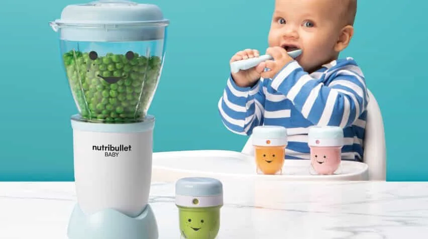 Baby enjoying their mashed peas from NutriBullet Baby