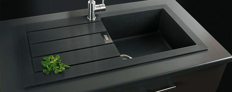 A black Tectonite sink with a silver tap