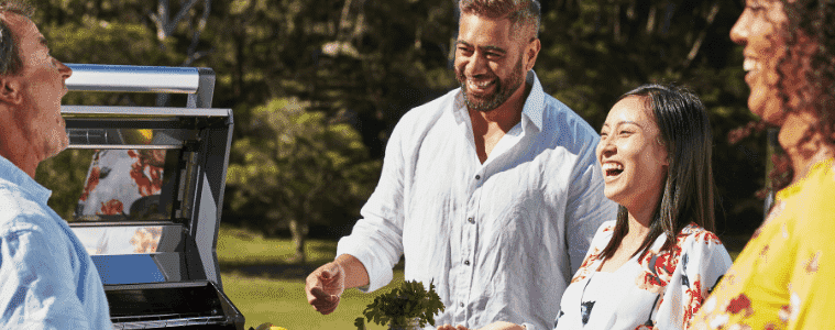 Family and friends enjoying their BeefEater BBQ in their outdoor kitchen area
