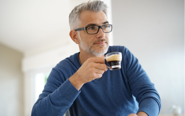 Father enjoying a freshly made espresso at home