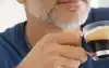 Father enjoying a freshly made espresso at home