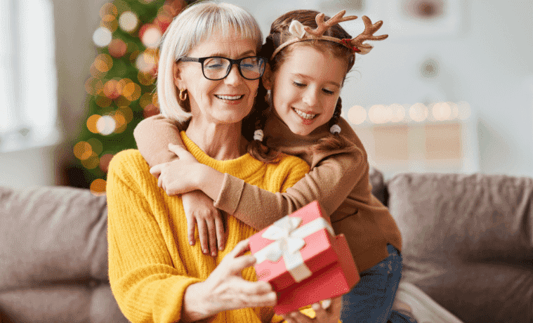 A grandmother opens a gift from her granddaughter