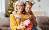 A grandmother opens a gift from her granddaughter