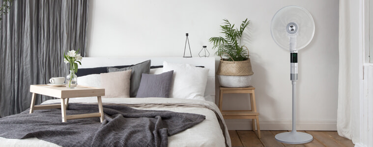 The DeLonghi 360 Degree Pedestal Cooling Fan cools down a modern bedroom