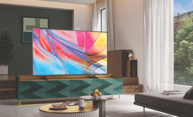 A UHD TV sits on a modern TV in a modern living room