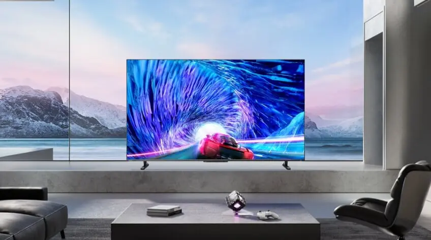 A Toshiba QLED TV in a sleek modern living room overlooking snowy mountains