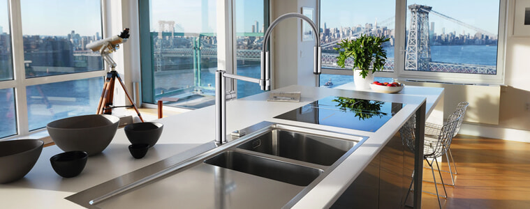 A chrome swivel mixer tap in a sleek modern apartment