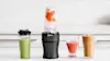 Image of smoothies and shakes lined up on a benchtop next to the Ninja Nutri Precision Blender Mega Pack