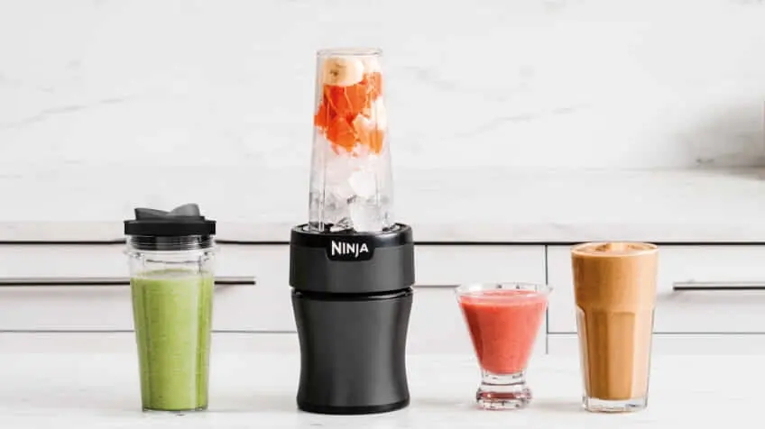 Image of smoothies and shakes lined up on a benchtop next to the Ninja Nutri Precision Blender Mega Pack