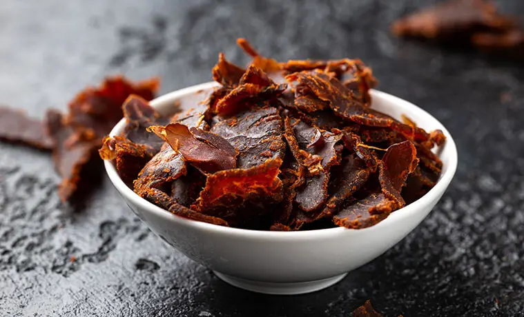 Dried beef jerky in a white snack bowl