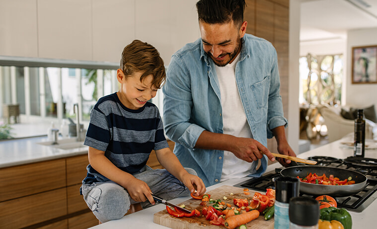 A father and son preparing a meal in the kitchen