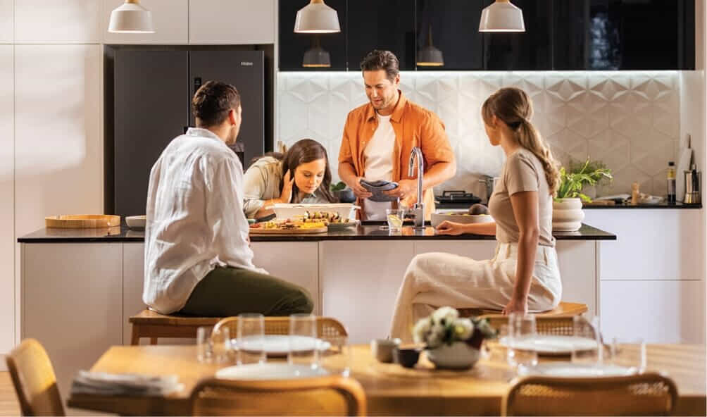 A group of friends share a meal in their Haier kitchen
