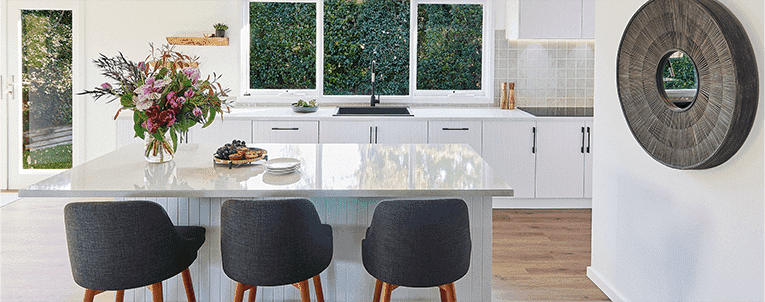 A white stainlesssteel kitchen designed by Kinsman