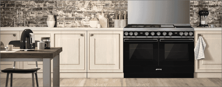 A double freestanding oven in a cream coloured kitchen