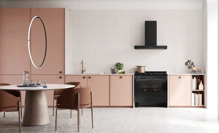 A light and airy pink kitchen with black appliances