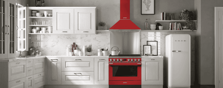 A striking red Smeg Portofino freestanding cooker and range hood in a white kitchen