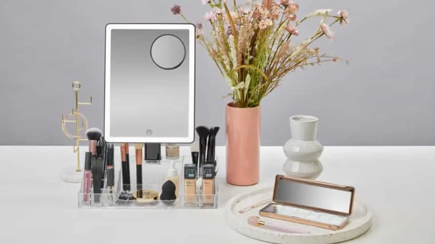 Homedics vanity mirror set up in a white modern counter with make up in a organiser