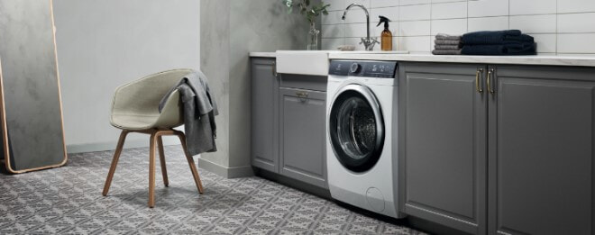 A greytoned laundry with lots of storage space