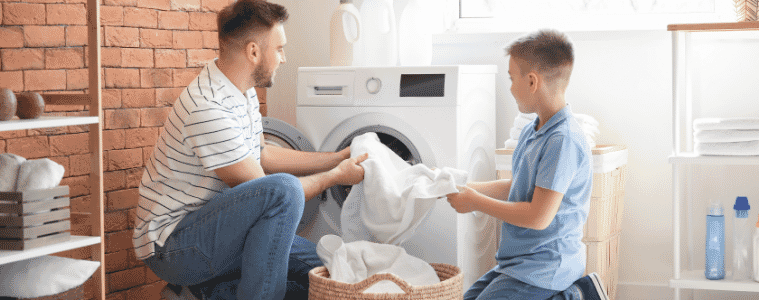Father and son enjoying doing their laundry together