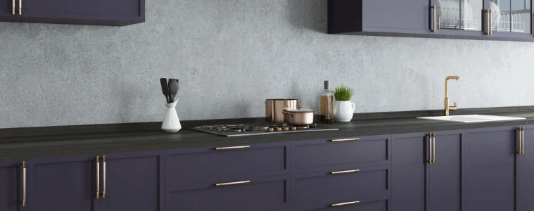 A navy and black kitchen with a dark grey concrete splashback