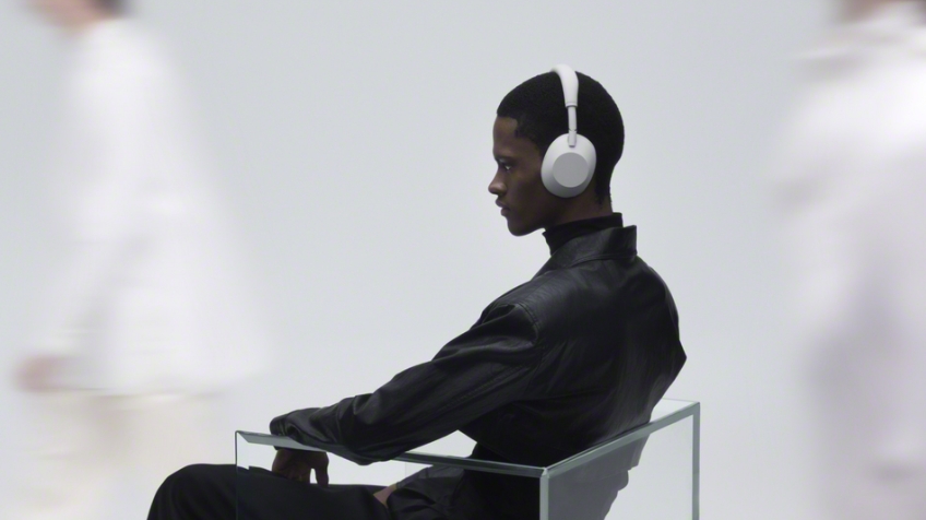 Man sitting down while wearing Sony Headphones