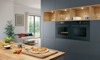 Pizzas being made in a modern kitchen featuring dual Bosch Series 8 Ovens 